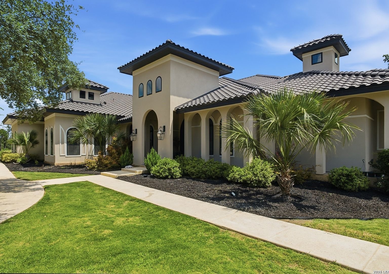 Front exterior with arched windows and tile roof