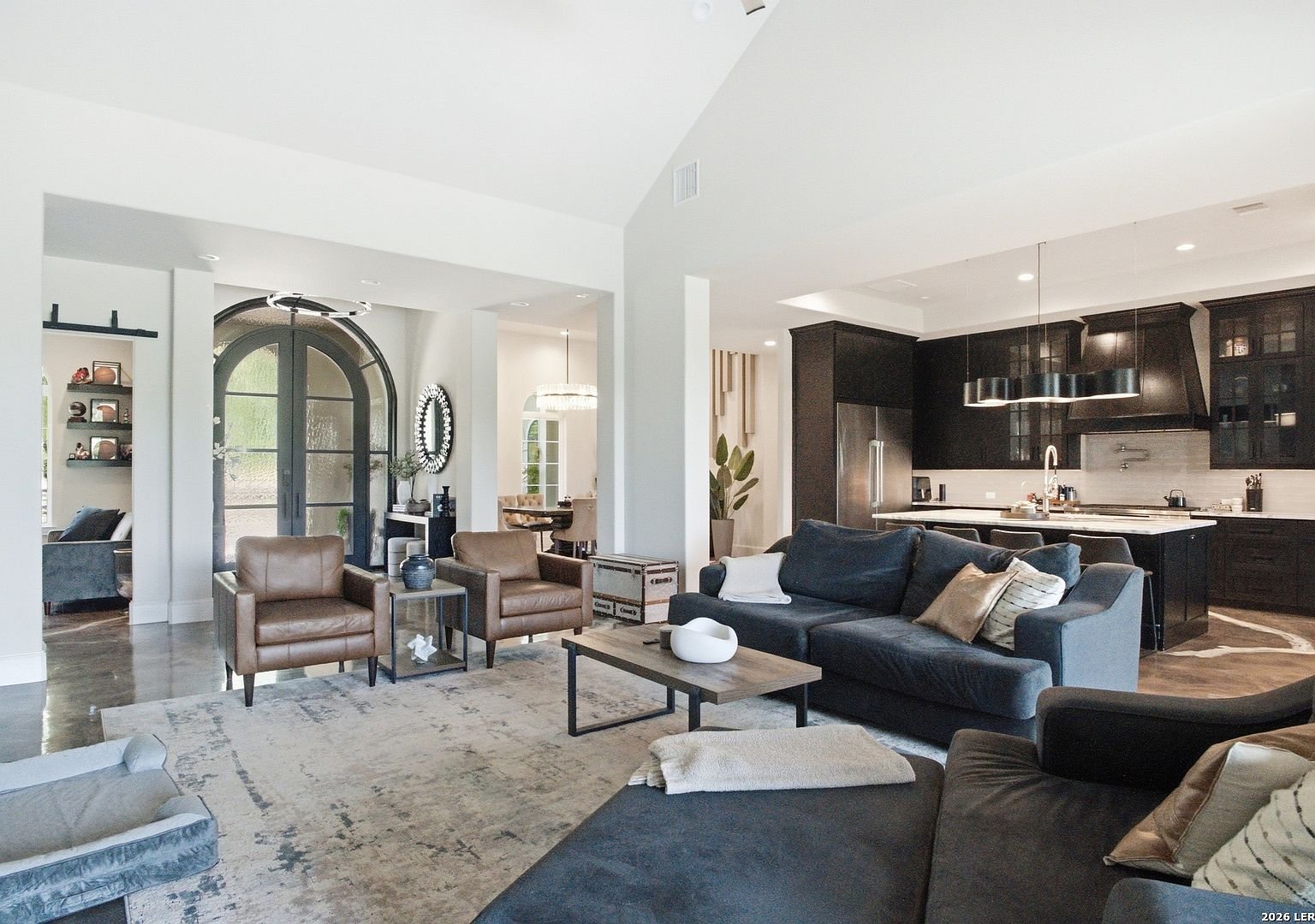 Living room with fireplace and open kitchen beyond