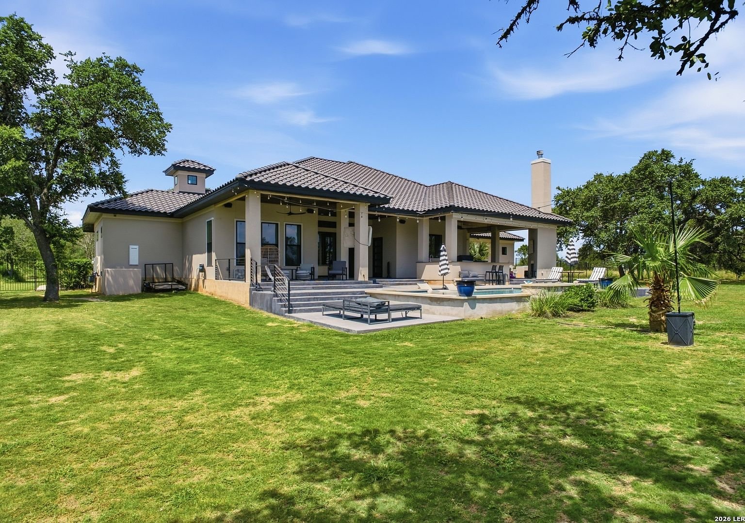 Rear exterior of 2928 Rustlers Trail with pool and covered patio